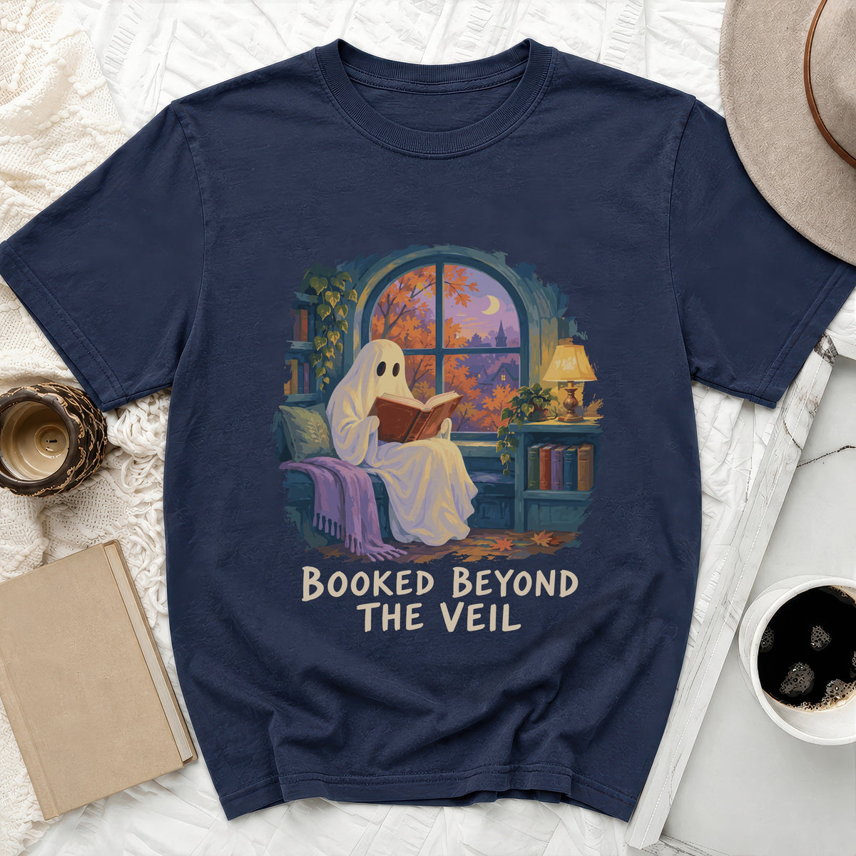 Navy t-shirt with ghost reading by a window and "Booked Beyond The Veil" text.