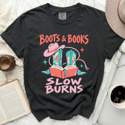 Black t-shirt with "Boots & Books Slow Burns" graphic featuring cowboy boots and hat.