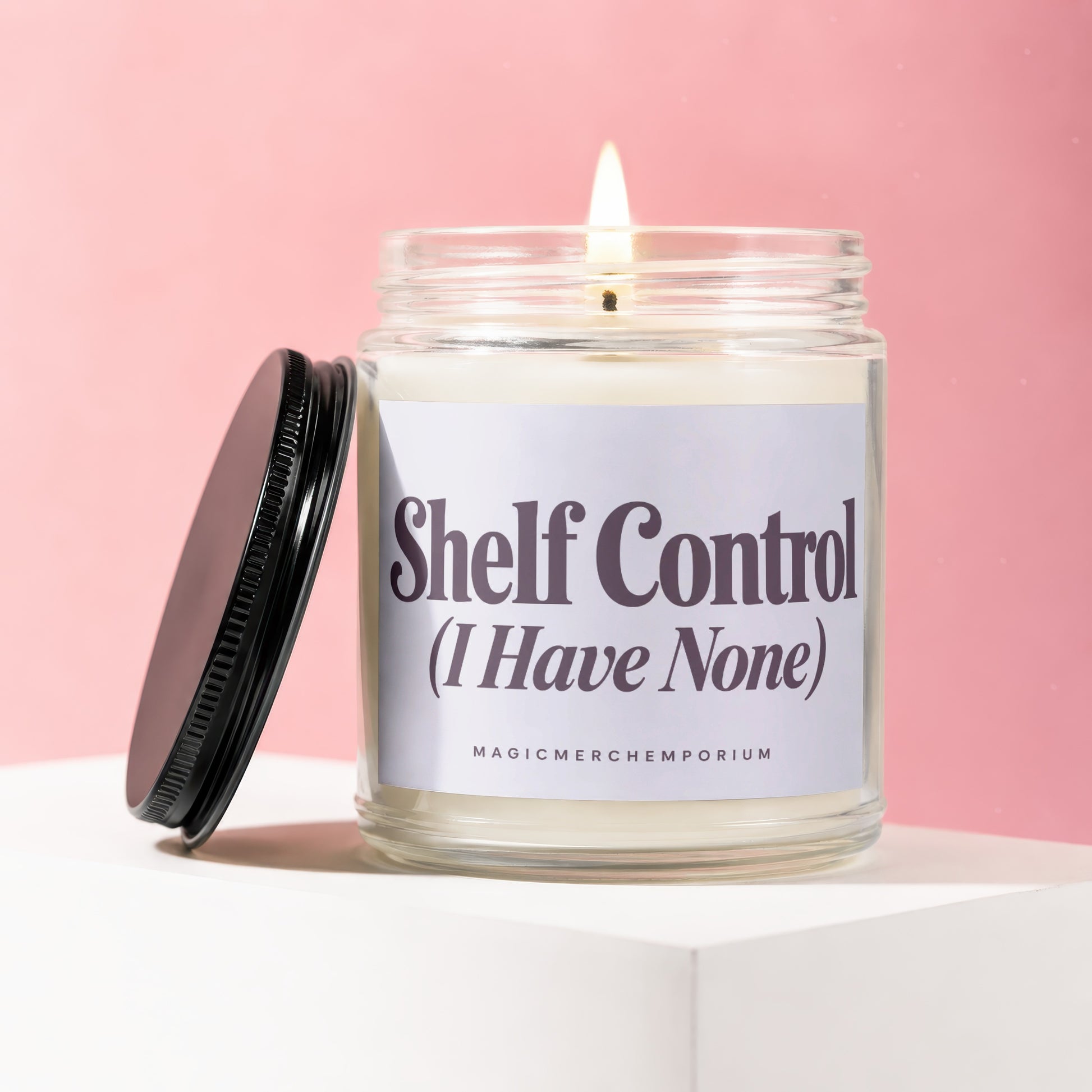 Candle in glass jar with label "Shelf Control (I Have None)".