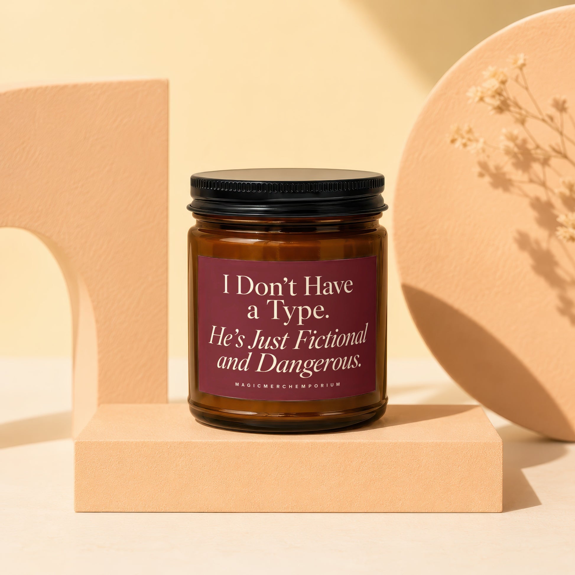 Amber jar candle with maroon label saying "I Don't Have a Type. He's Just Fictional and Dangerous."