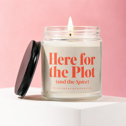 Jar candle with orange text "Here for the Plot (and the Spice)" on a pink background.