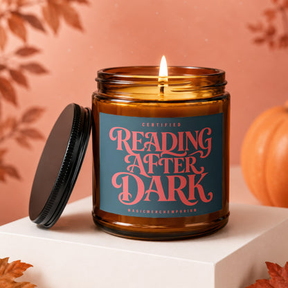 Amber glass candle with "Reading After Dark" and "MagicMerchEmporium" text on label.