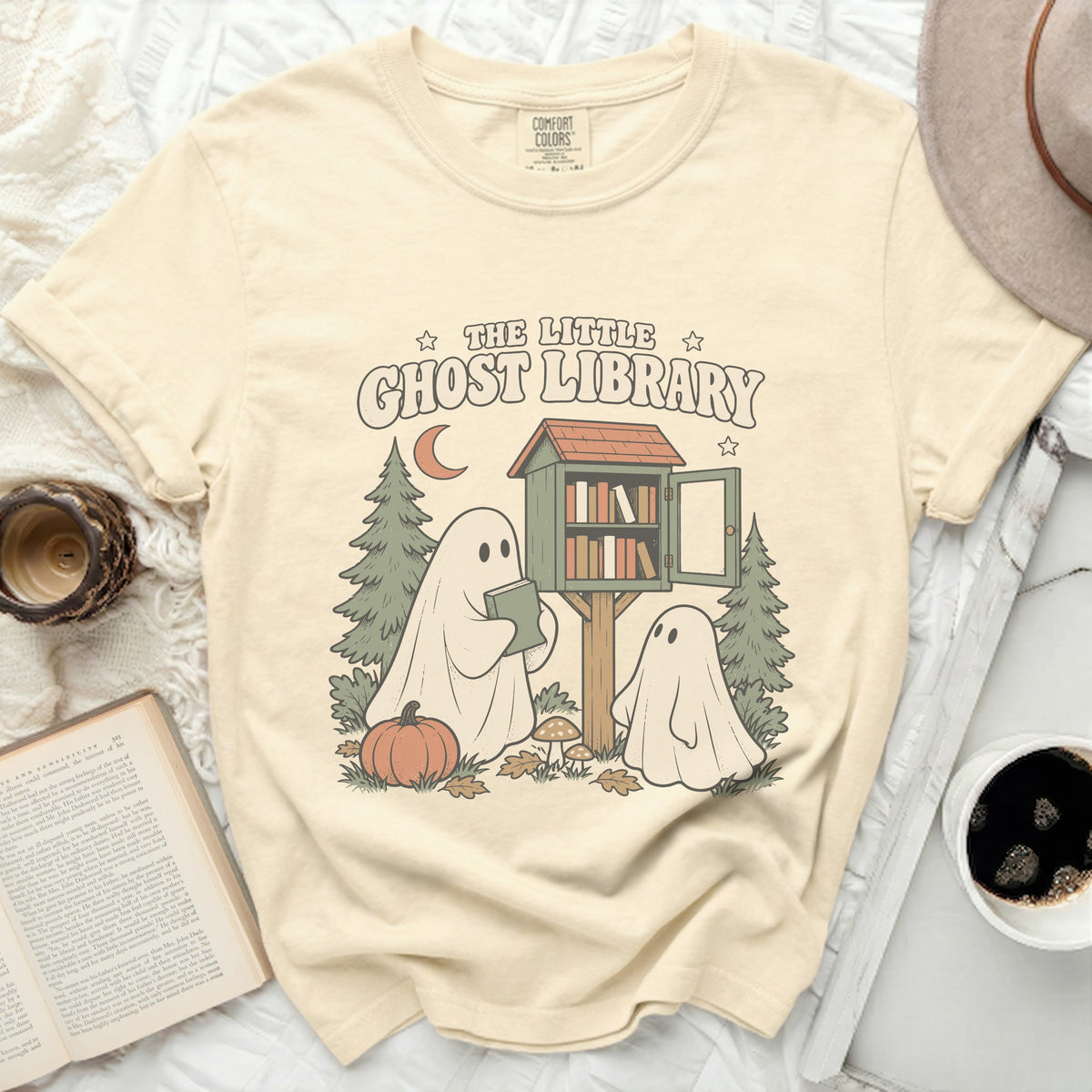 The Little Ghost Library graphic on a cream Comfort Colors t-shirt.