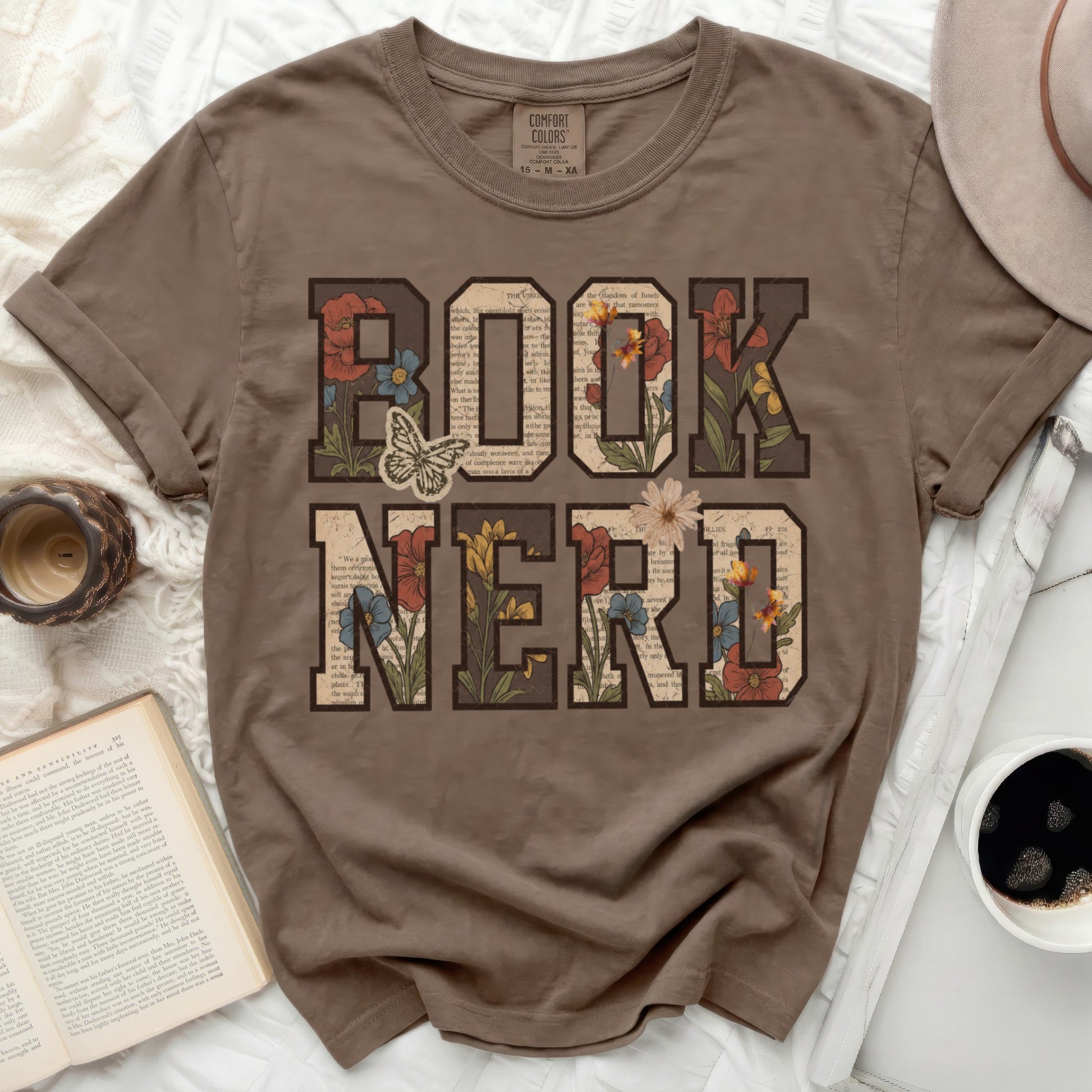 Brown t-shirt with "BOOK NERD" text and floral accents.