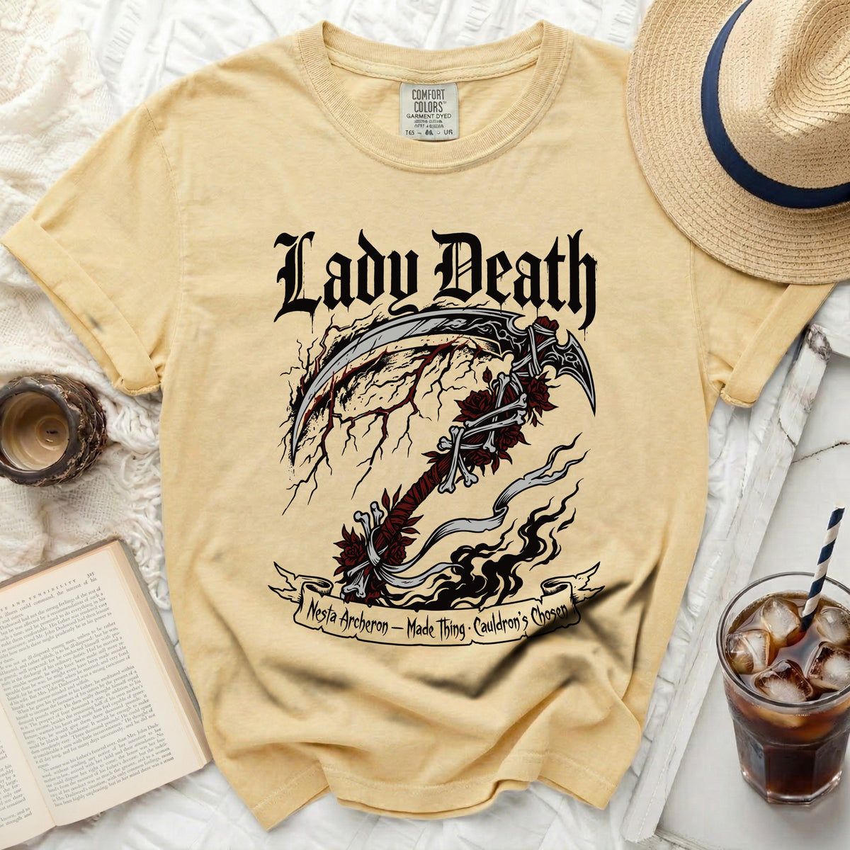 Yellow Comfort Colors t-shirt with Lady Death scythe graphic and text.