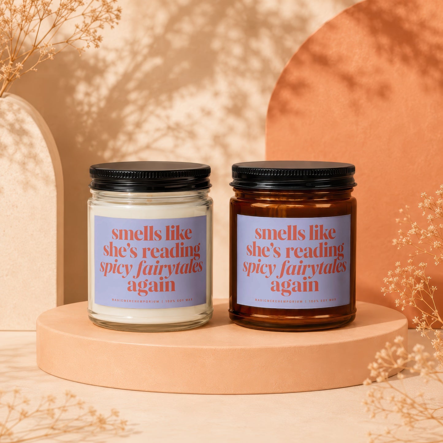 Two soy wax candles with labels reading "smells like she's reading spicy fairytales again."