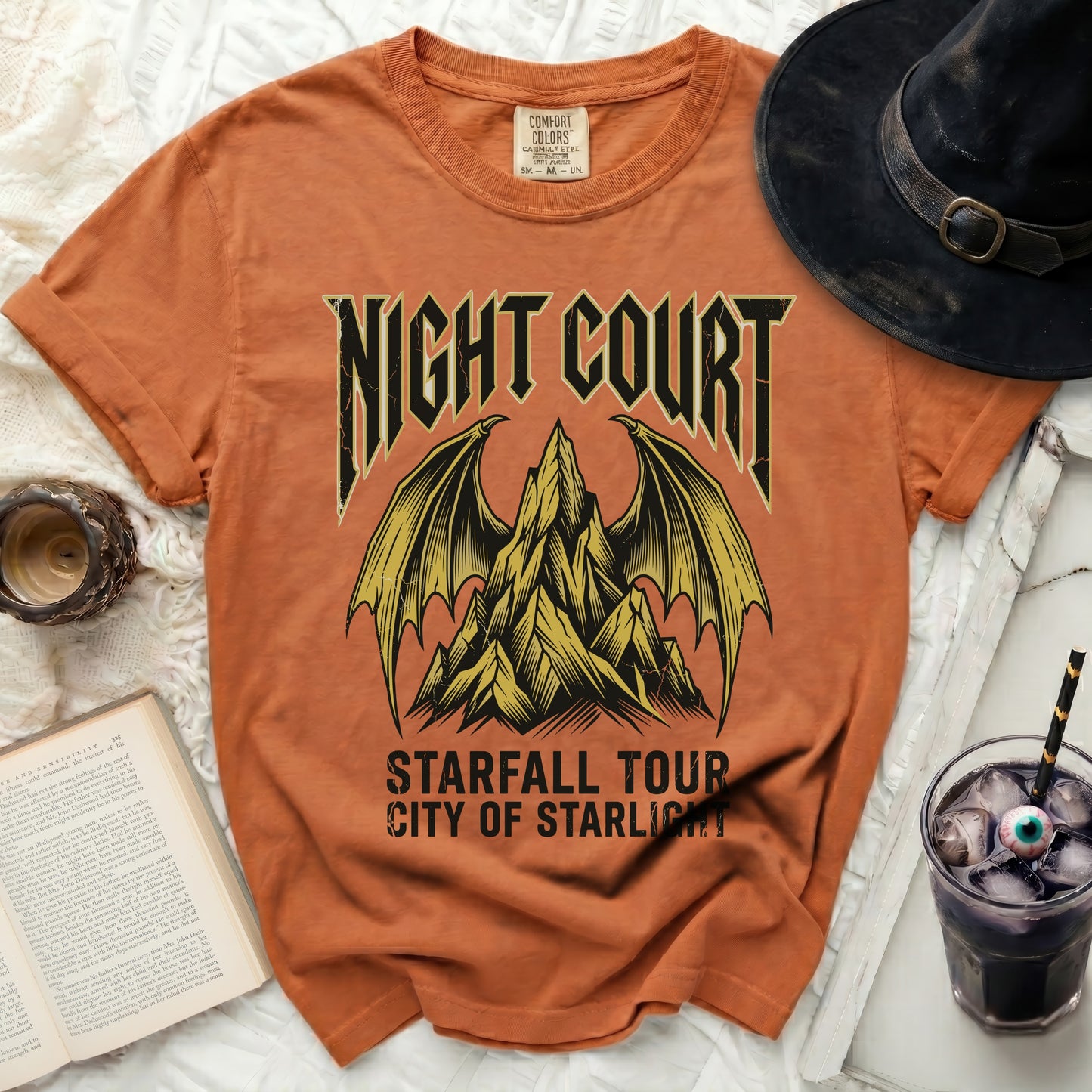 Orange t-shirt with "Night Court Starfall Tour City of Starlight" graphic.