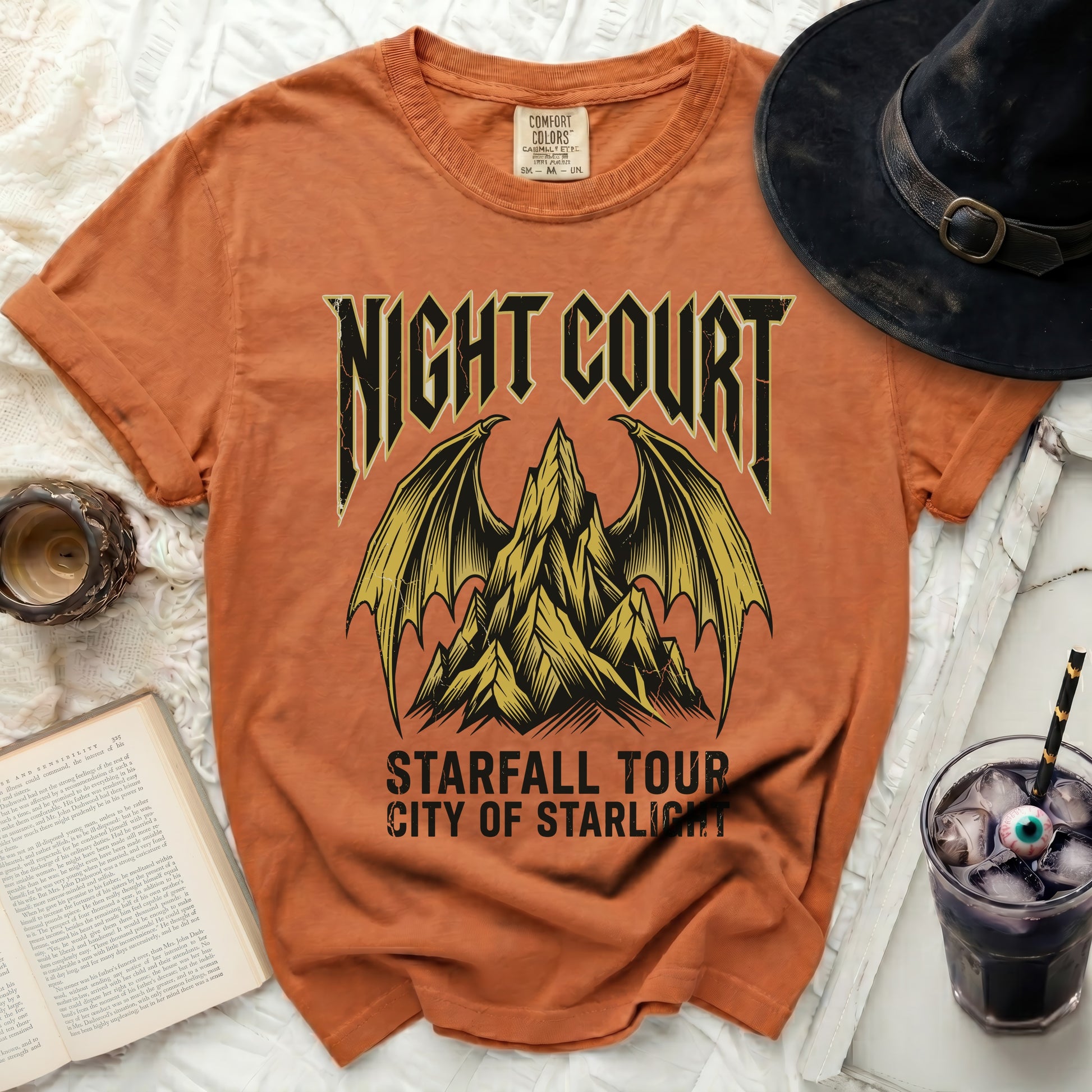 Orange t-shirt with "Night Court Starfall Tour City of Starlight" graphic.