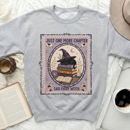 Gray sweatshirt with "Just One More Chapter Said Every Witch" graphic.