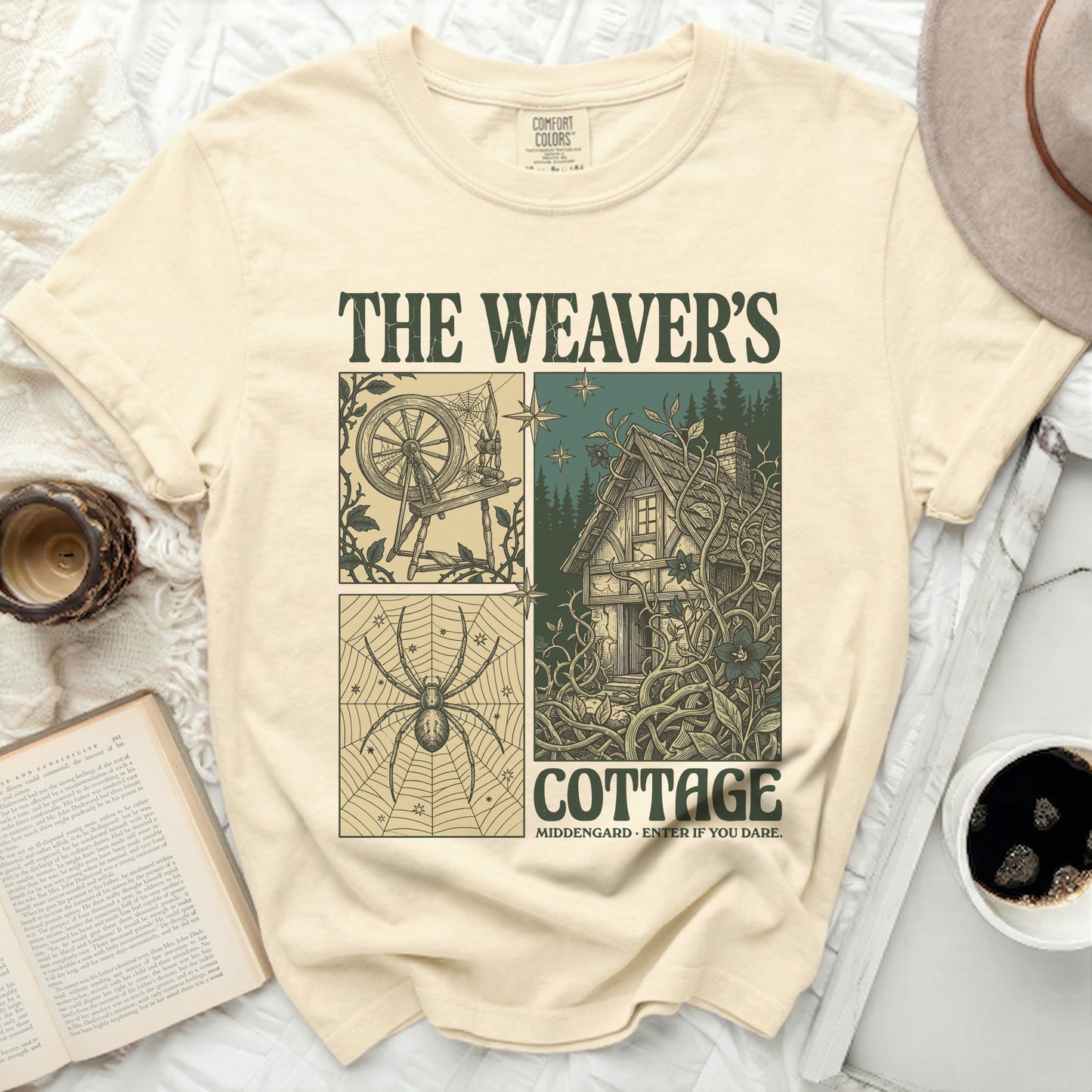 The Weaver's Cottage t-shirt features a four-panel design with a spinning wheel, spider, cottage, and text.