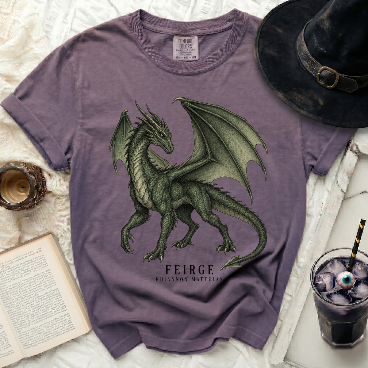 Purple t-shirt with a green dragon graphic and "FEIRGE RHIANNON MATTHIAS" text.