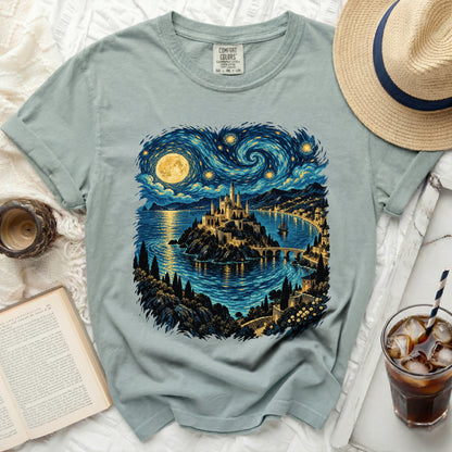 Light blue t-shirt featuring a castle on an island under a swirling starry sky.
