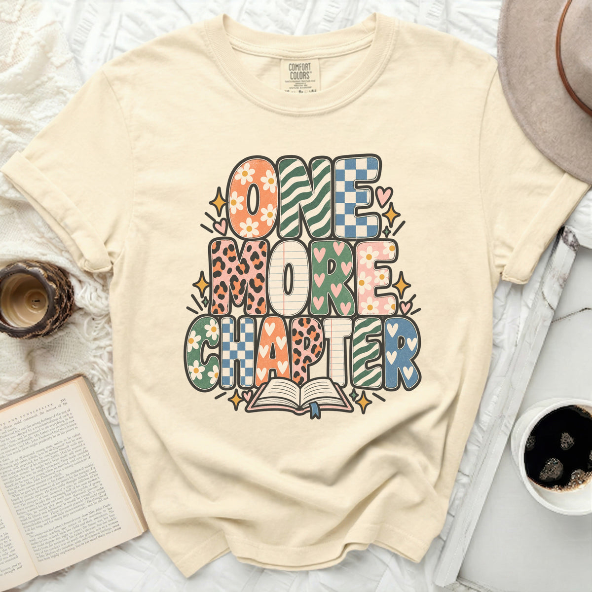 Comfort Colors t-shirt with "ONE MORE CHAPTER" graphic and open book.
