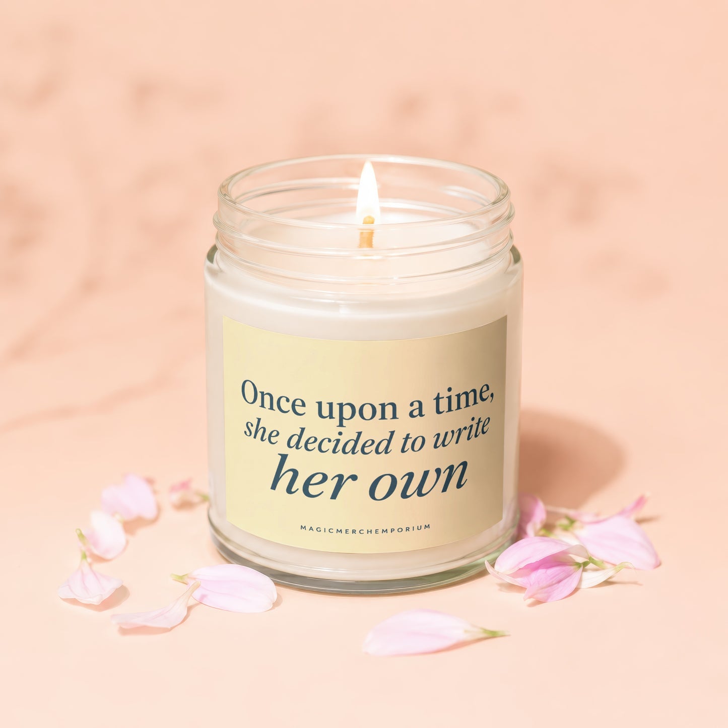 Candle with lit wick and text "Once upon a time, she decided to write her own."