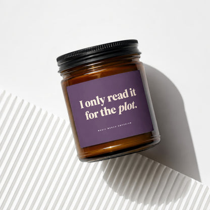 Brown glass candle with purple label reading "I only read it for the plot."