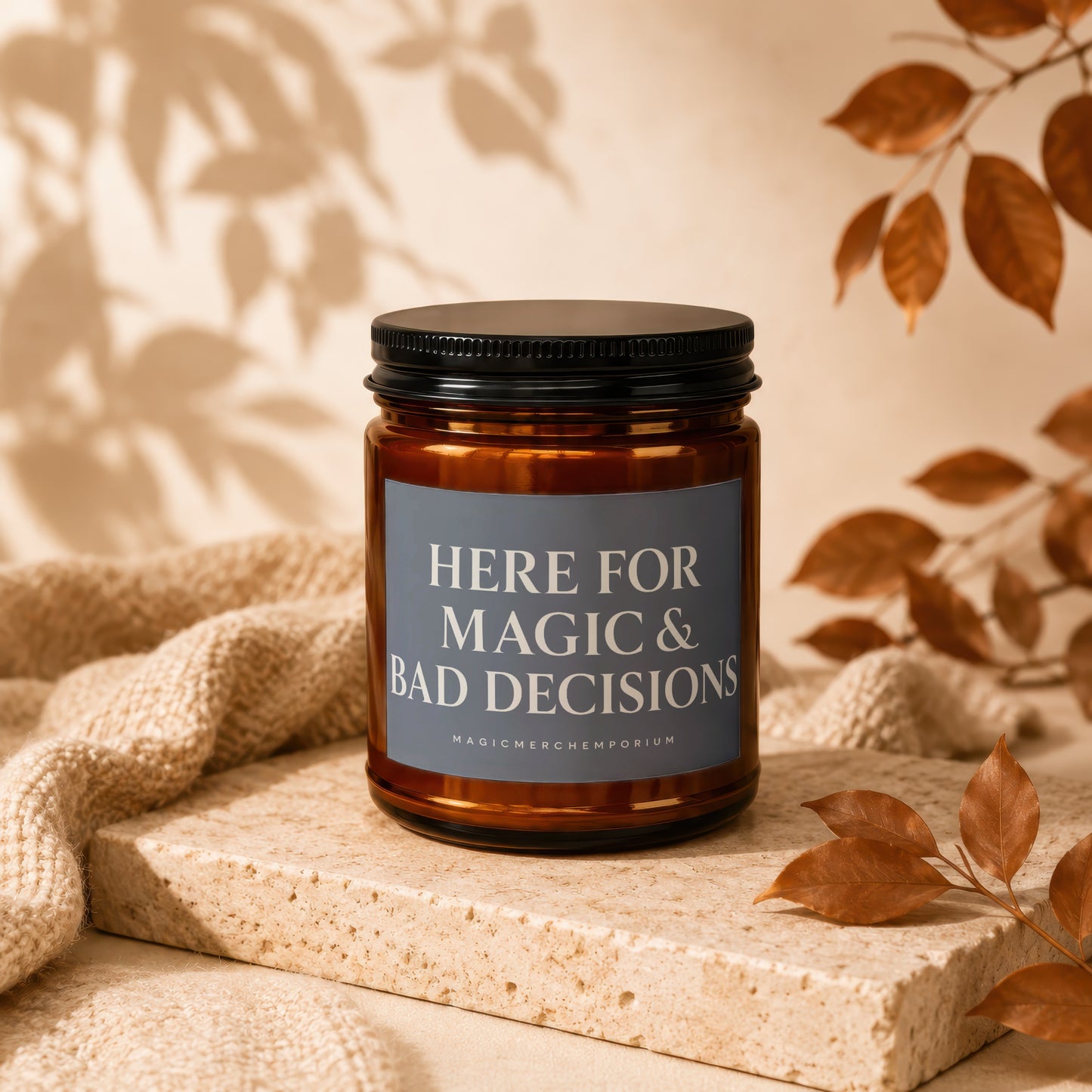 Amber candle with black lid labeled "HERE FOR MAGIC & BAD DECISIONS".