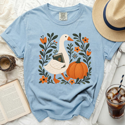 Light blue Comfort Colors t-shirt with goose, book, pumpkin, and floral graphic.