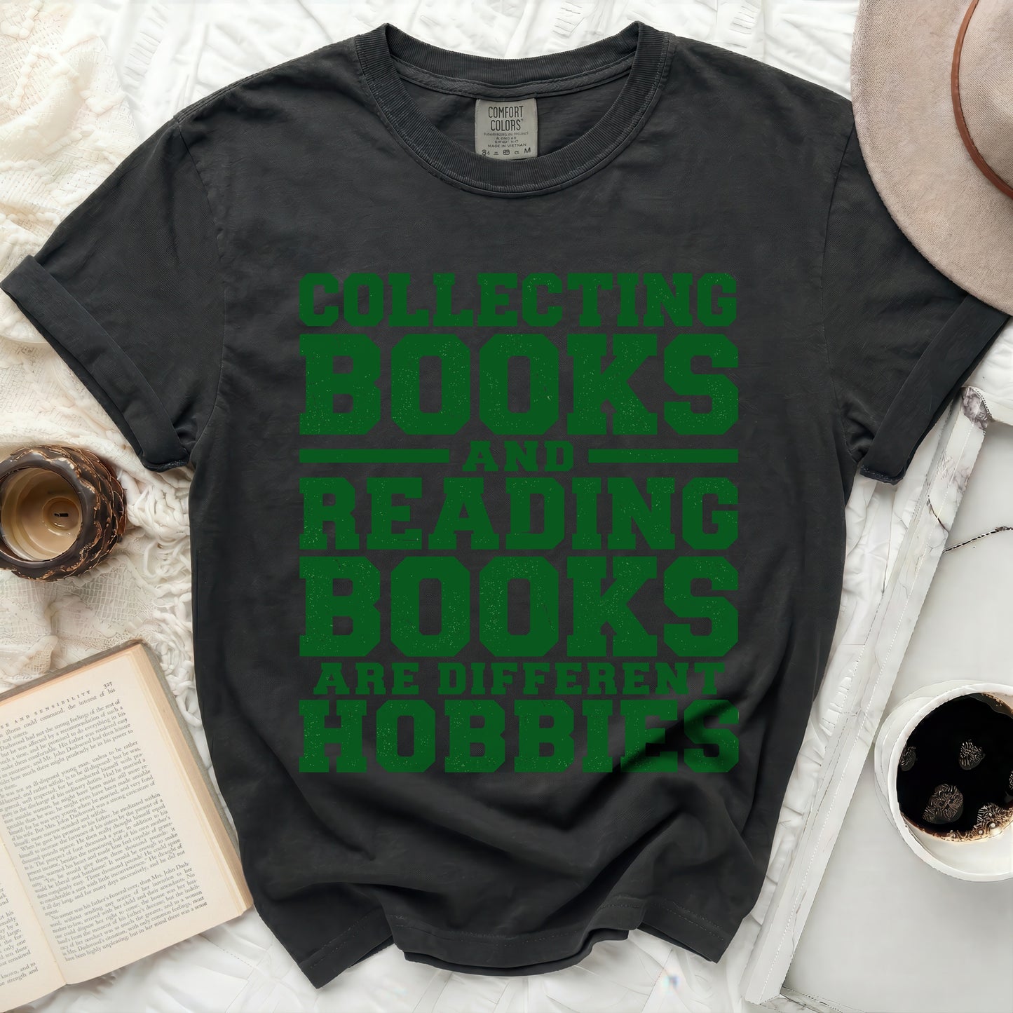 Dark t-shirt with green text "Collecting Books Reading Books Are Different Hobbies".