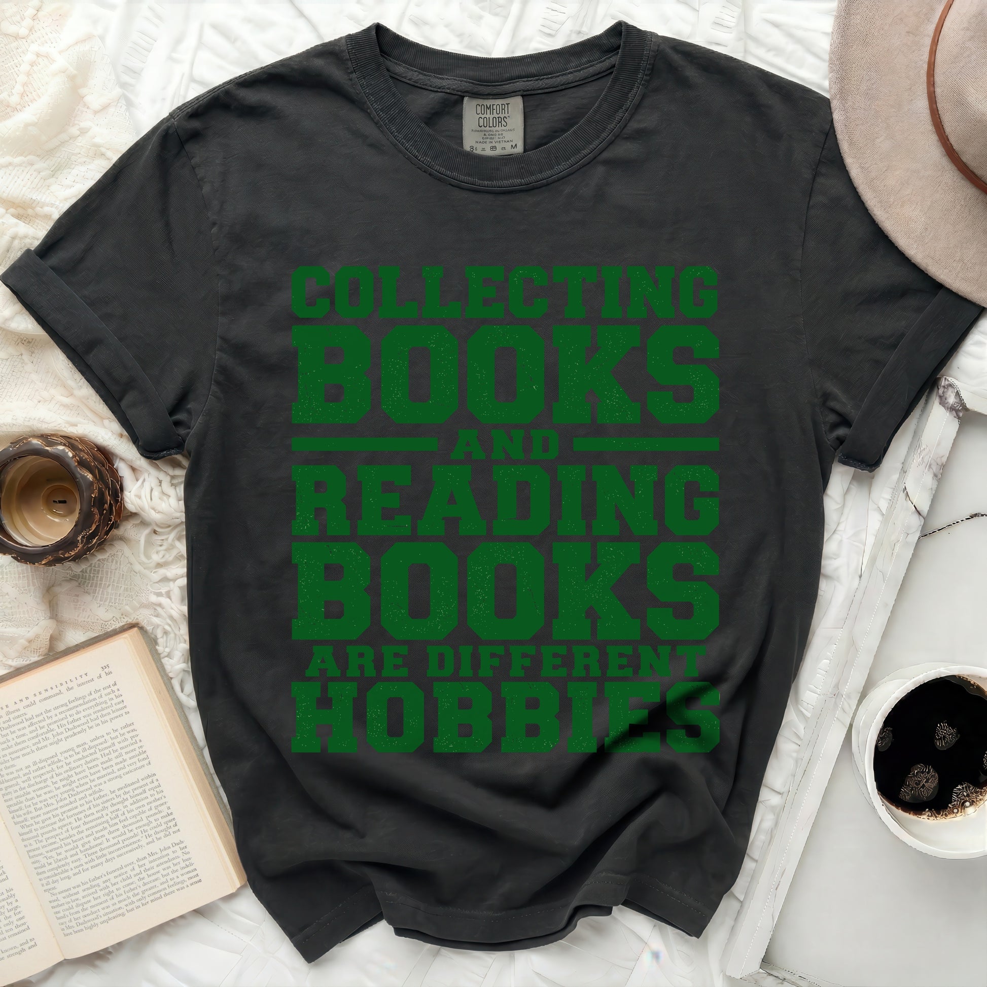 Dark t-shirt with green text "Collecting Books Reading Books Are Different Hobbies".