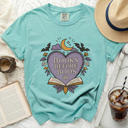 Teal t-shirt with "Books Before Boos" graphic and Halloween elements.