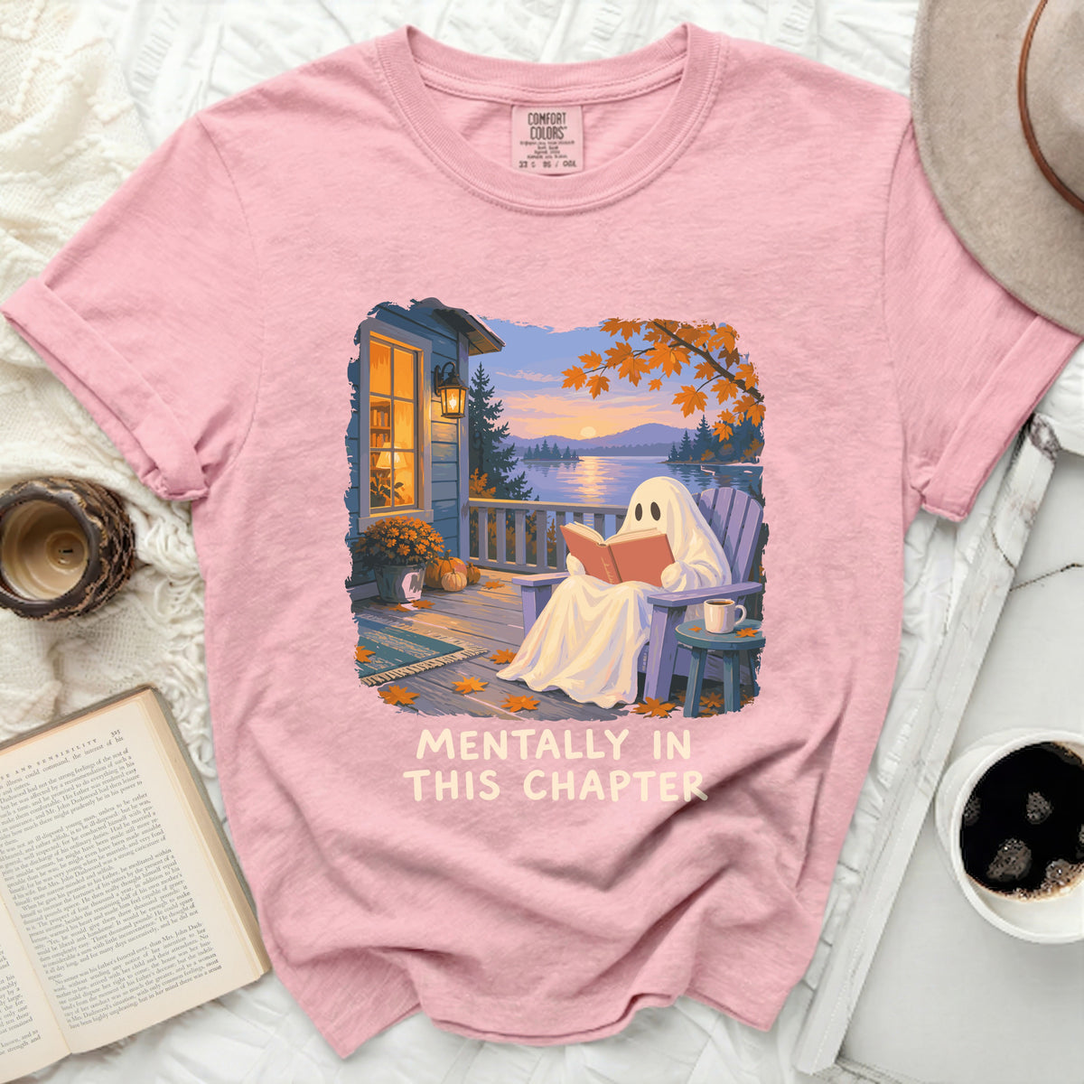 Pink t-shirt with graphic of ghost reading on a porch, "Mentally In This Chapter" text.