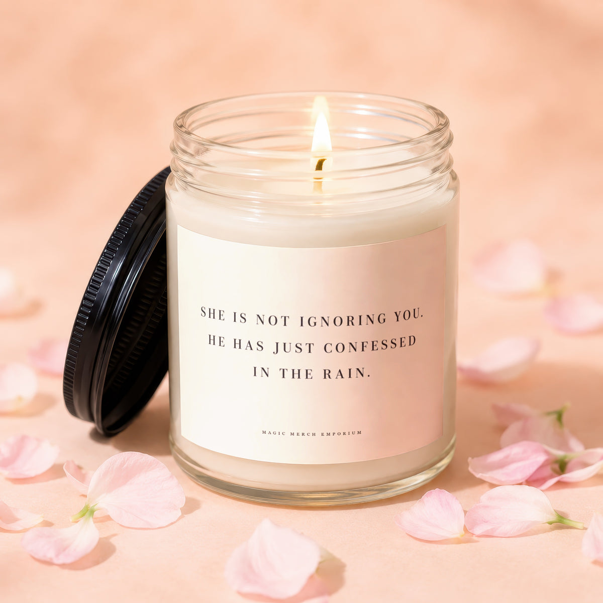 Candle with text "SHE IS NOT IGNORING YOU. HE HAS JUST CONFESSED IN THE RAIN."
