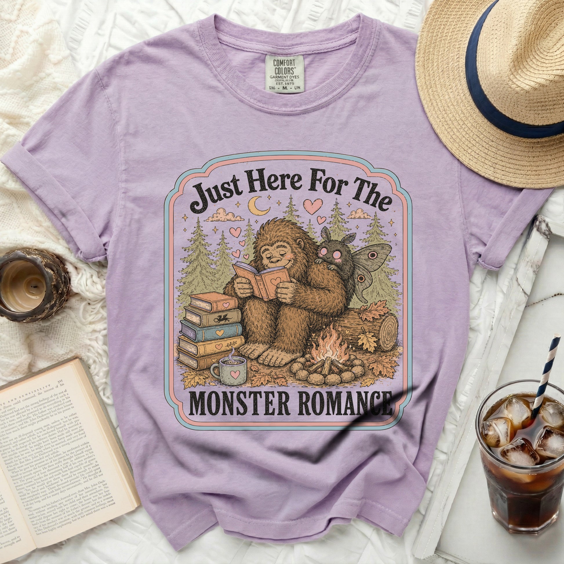 Lavendar t-shirt with Bigfoot reading a book and "Just Here For The MONSTER ROMANCE" text.