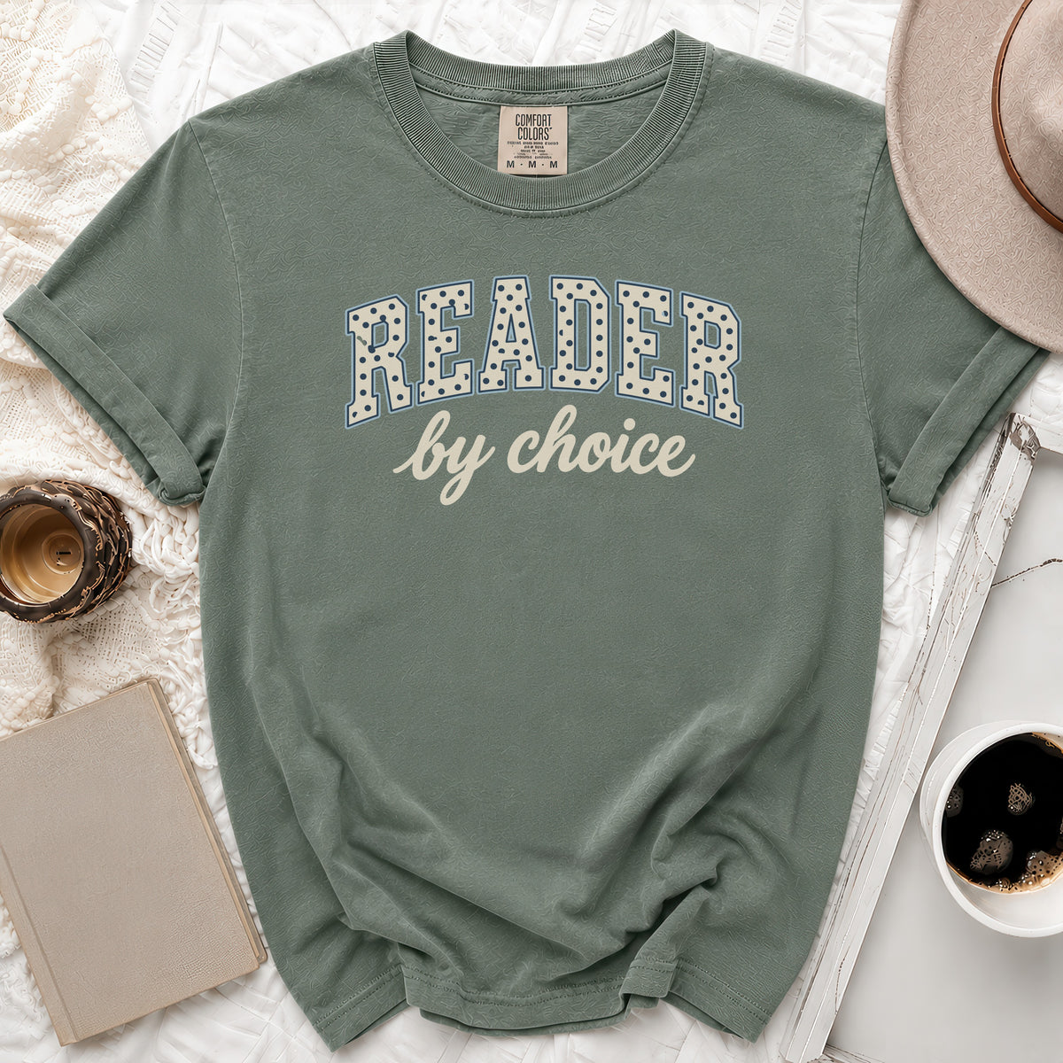 Green t-shirt with "READER by choice" text in a dotted collegiate font.
