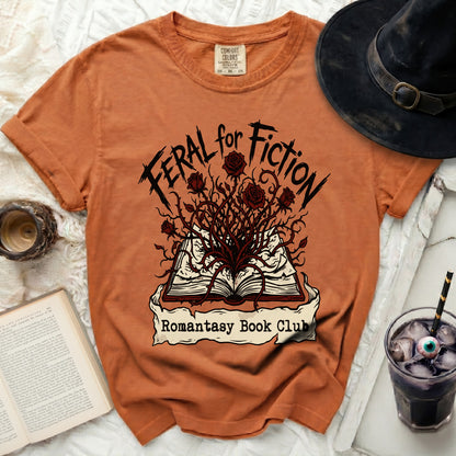 Orange t-shirt with "Feral for Fiction Romantasy Book Club" graphic.
