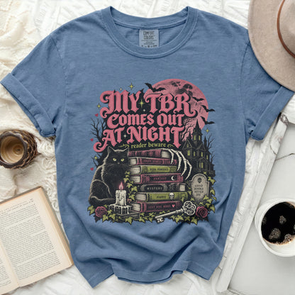 Blue t-shirt with "My TBR Comes Out At Night" text and Halloween-themed book illustrations.