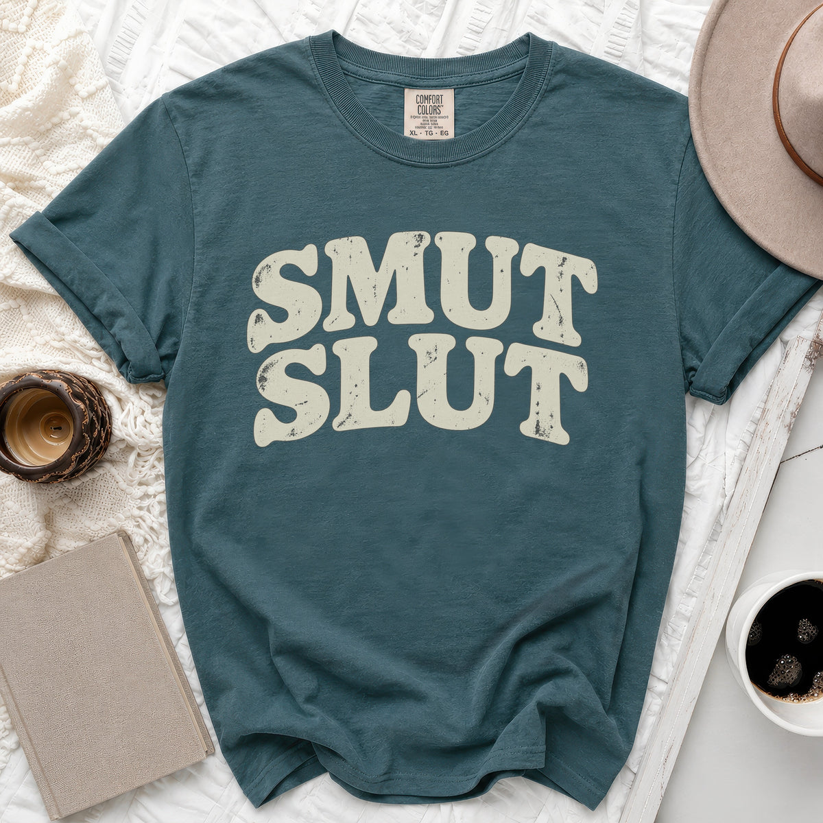 Teal Comfort Colors t-shirt with distressed "SMUT SLUT" graphic.