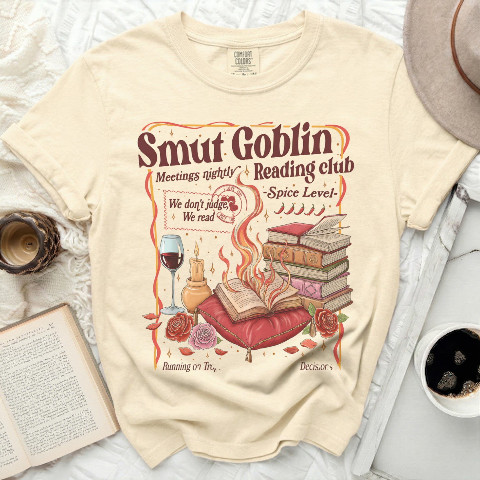 Cream t-shirt with "Smut Goblin Reading club" graphic and a wine glass.