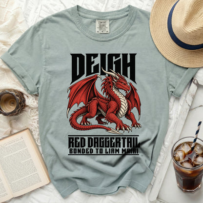Light blue t-shirt with red dragon graphic and text "DEIGH RED DAGGERTAIL BONDED TO LIAM MAIRI".