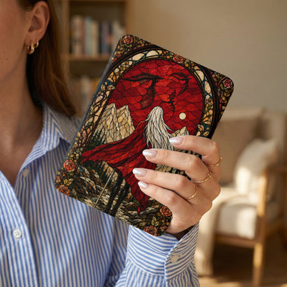 Book cover with stained glass art of a winged figure and mountains.