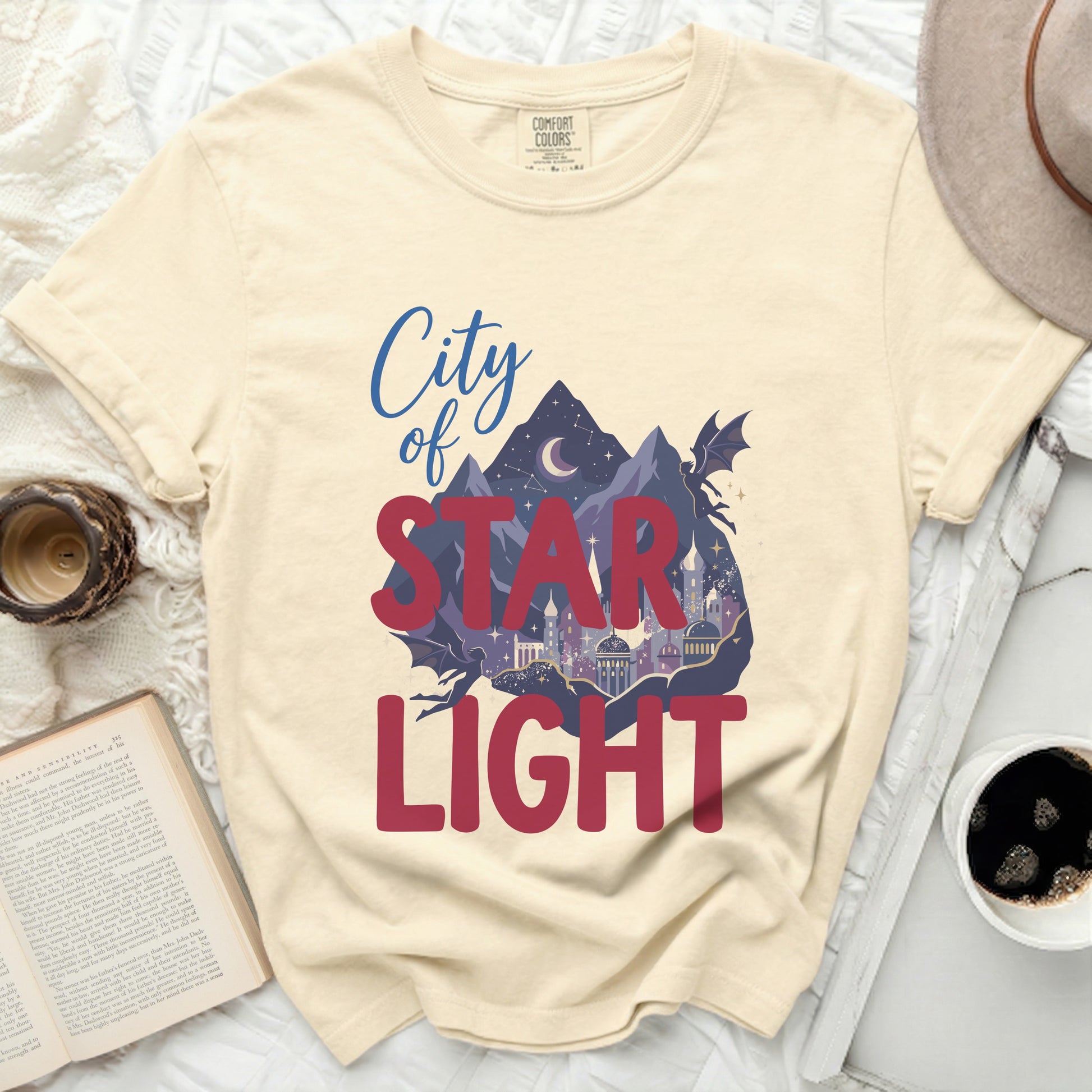 Cream t-shirt with "City of Star Light" text and fantasy scene.