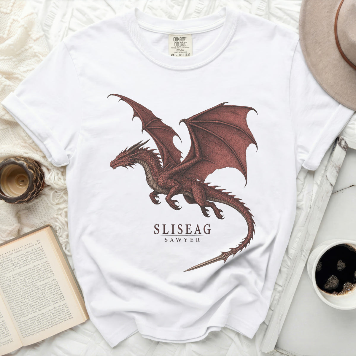 White t-shirt with a red dragon graphic and text "SLISEAG SAWYER".