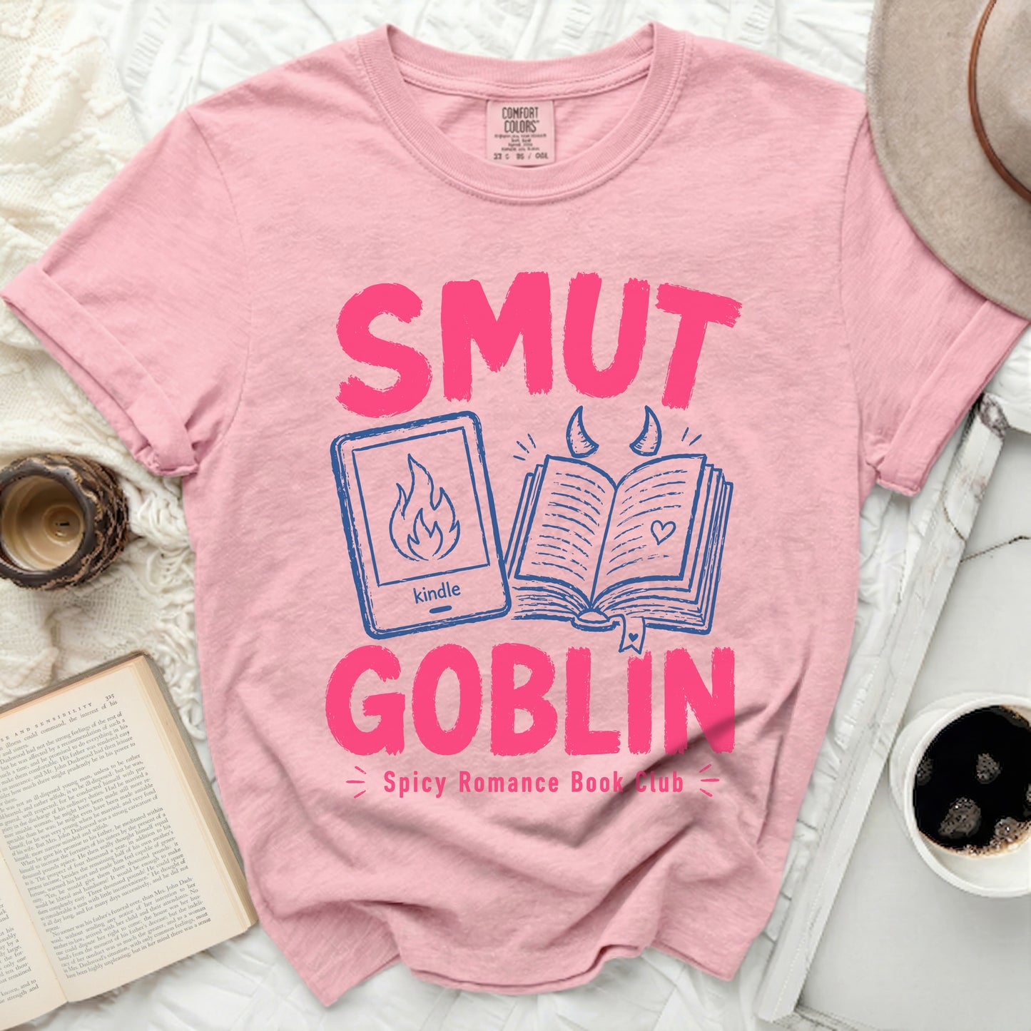 Pink t-shirt with "Smut Goblin Spicy Romance Book Club" text and kindle icon.