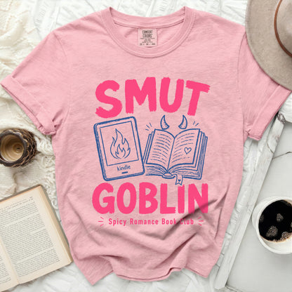 Pink t-shirt with "Smut Goblin Spicy Romance Book Club" text and kindle icon.