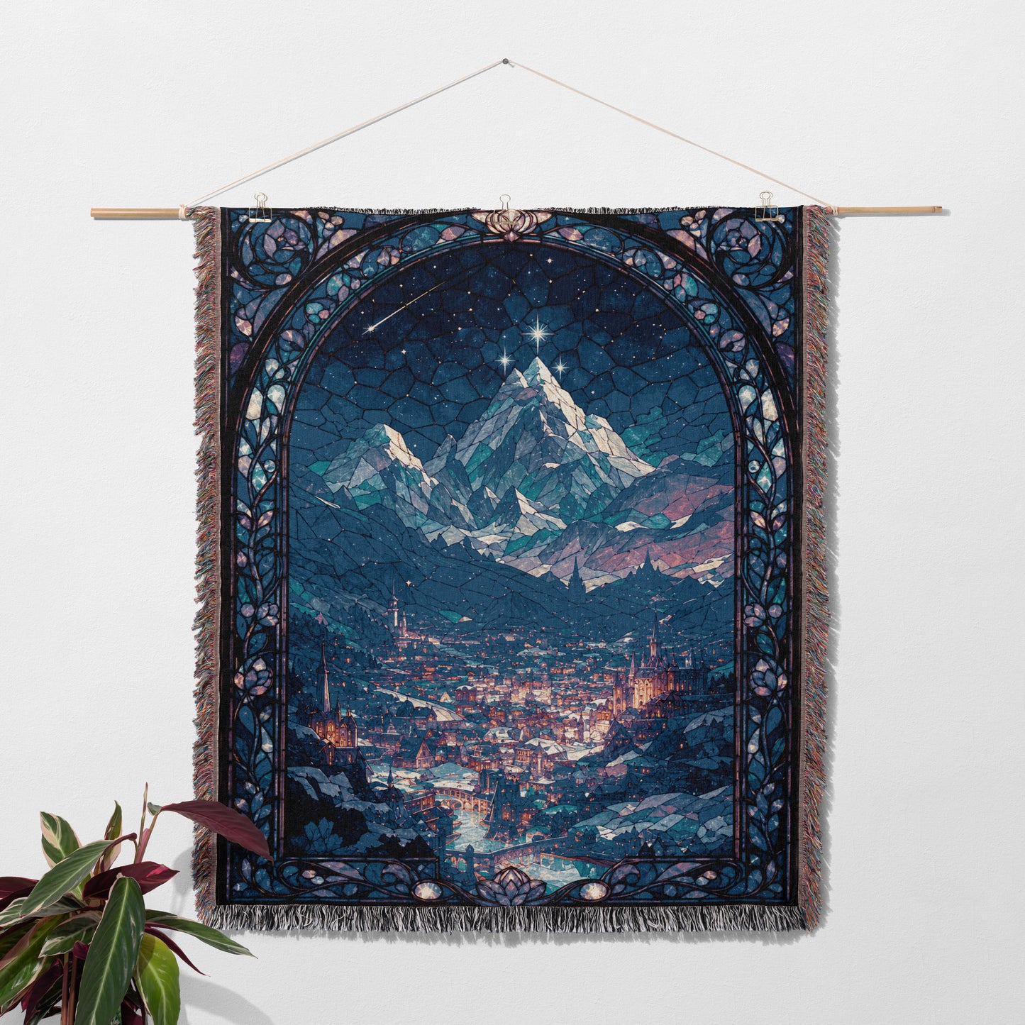 a large tapestry hanging on a wall, depicting a mountainous landscape with a city in the distance.