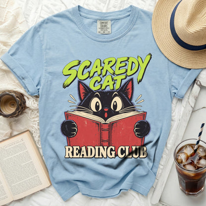 Light blue t-shirt with a black cat reading a book and text "SCAREDY CAT READING CLUB".