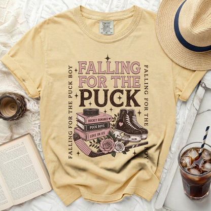 Yellow t-shirt with "Falling for the Puck Boy" text and hockey imagery.