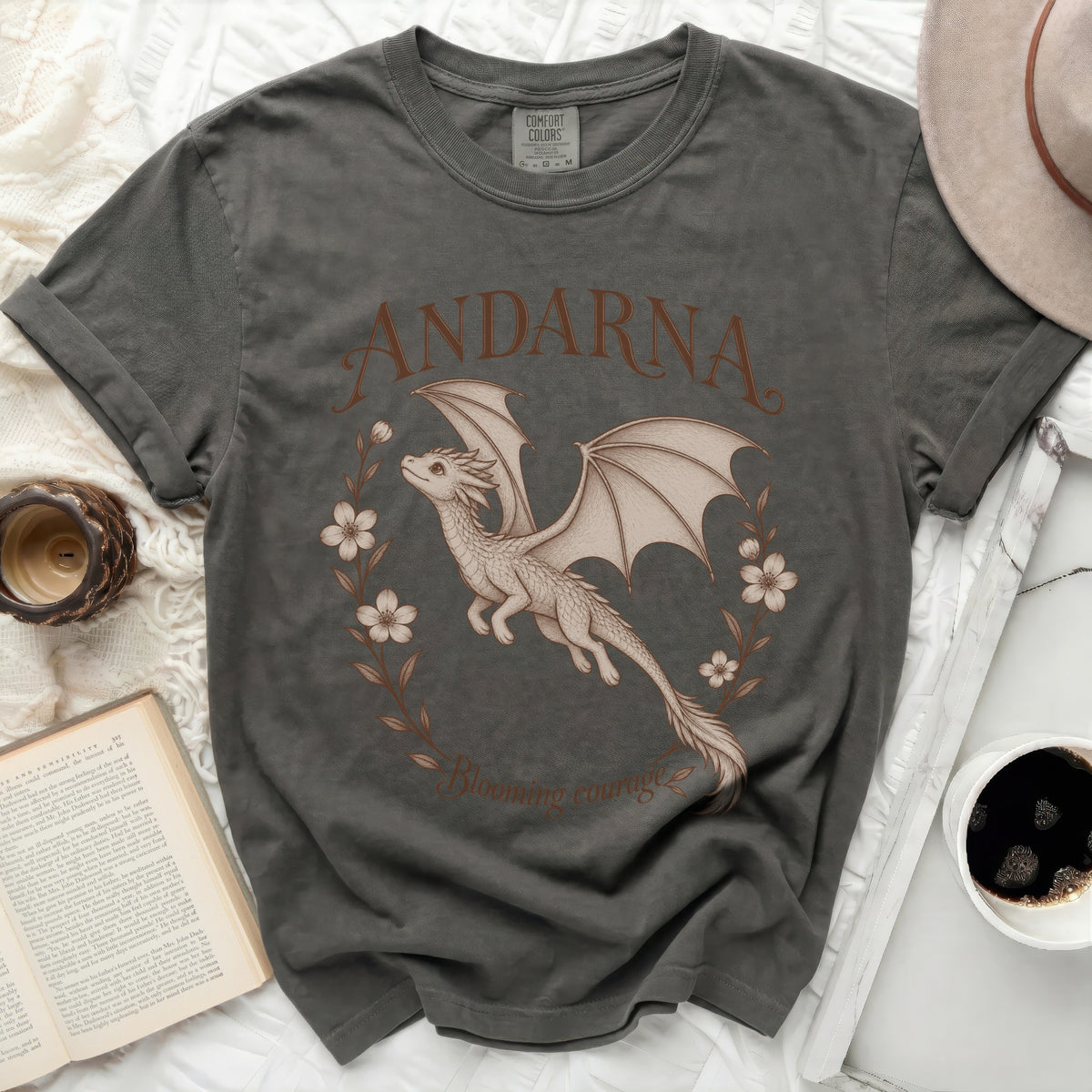 Dark gray t-shirt with a dragon, flowers, and text "ANDARNA Blooming courage."