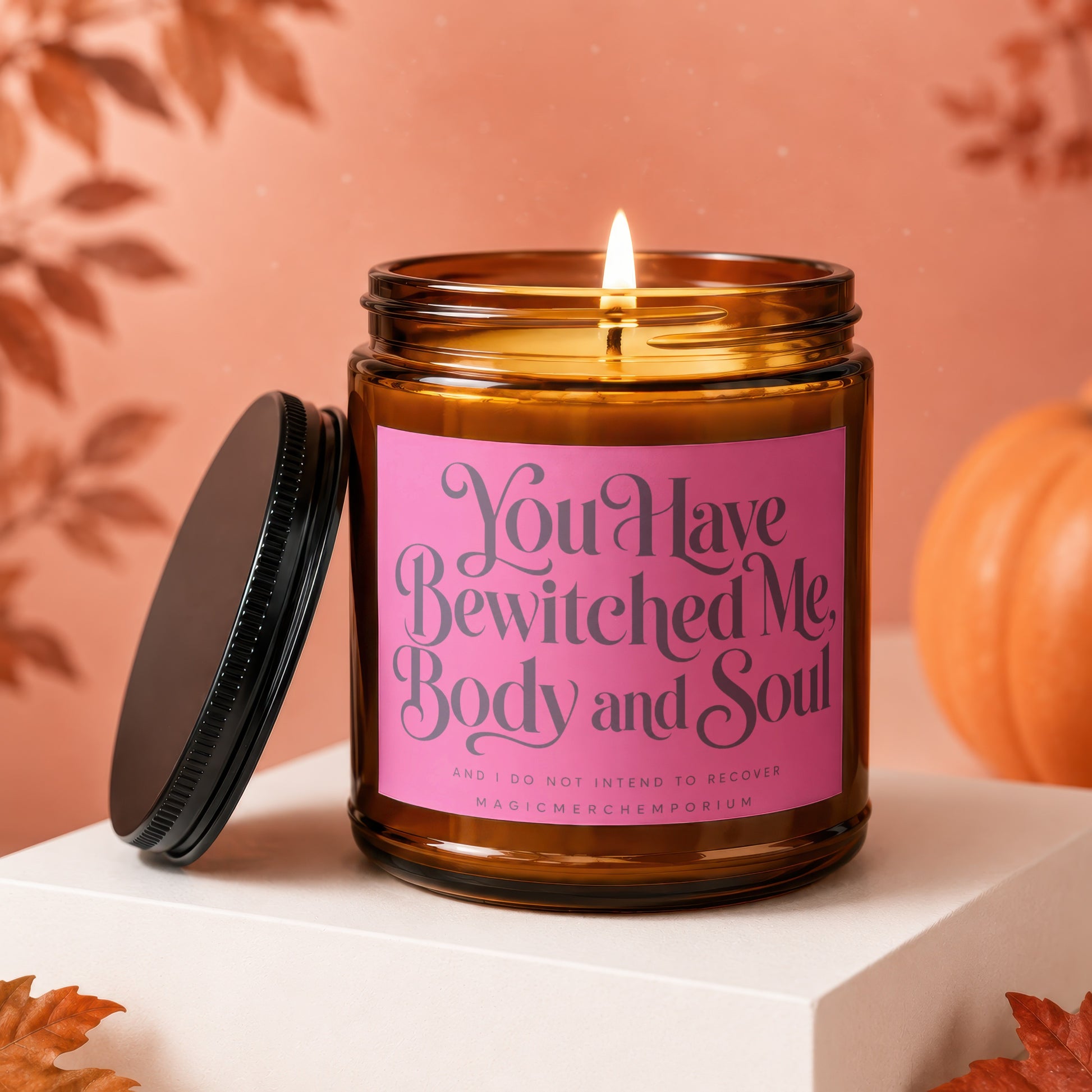 Amber candle with a pink label that reads "You Have Bewitched Me, Body and Soul".