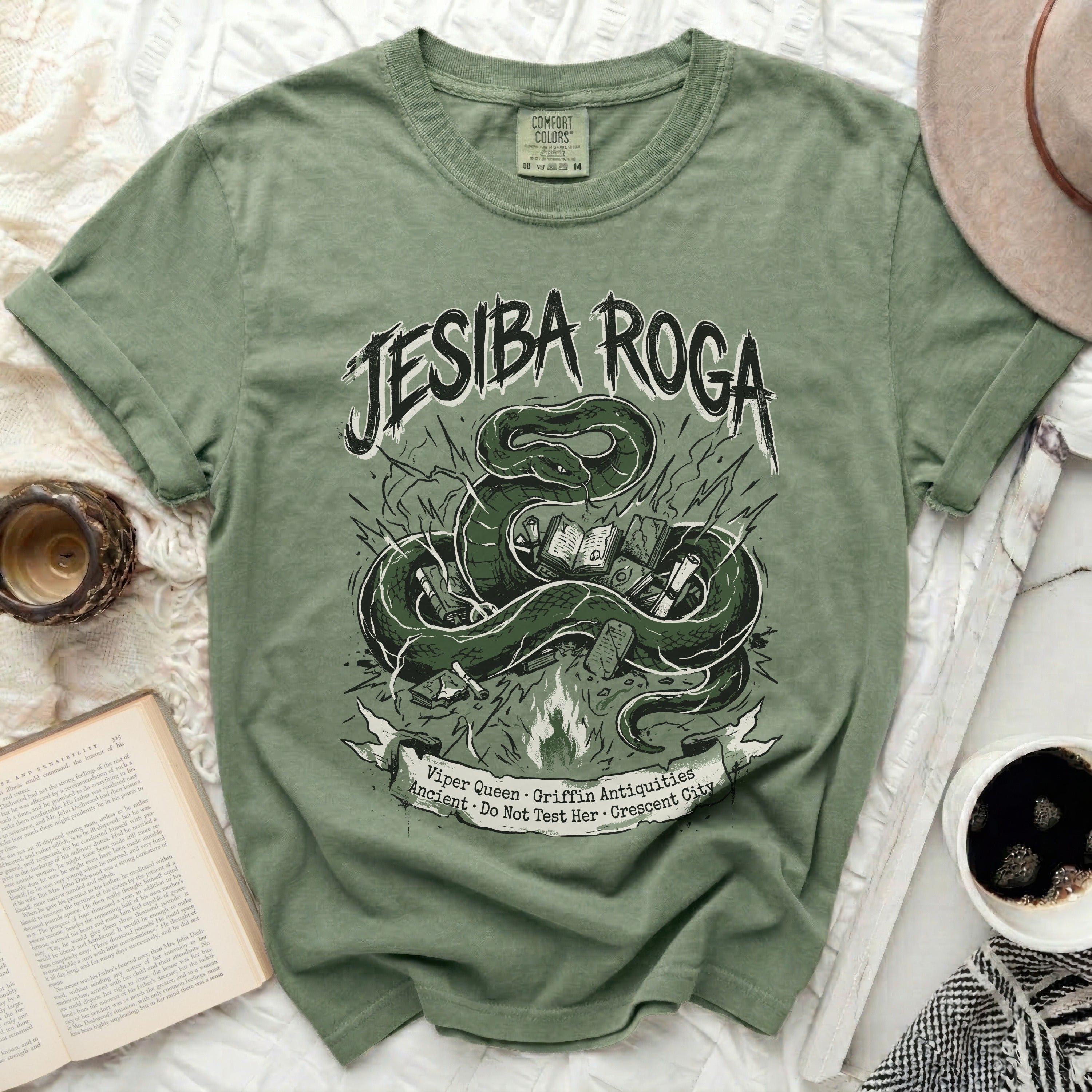 Green t-shirt with snake, books, and 