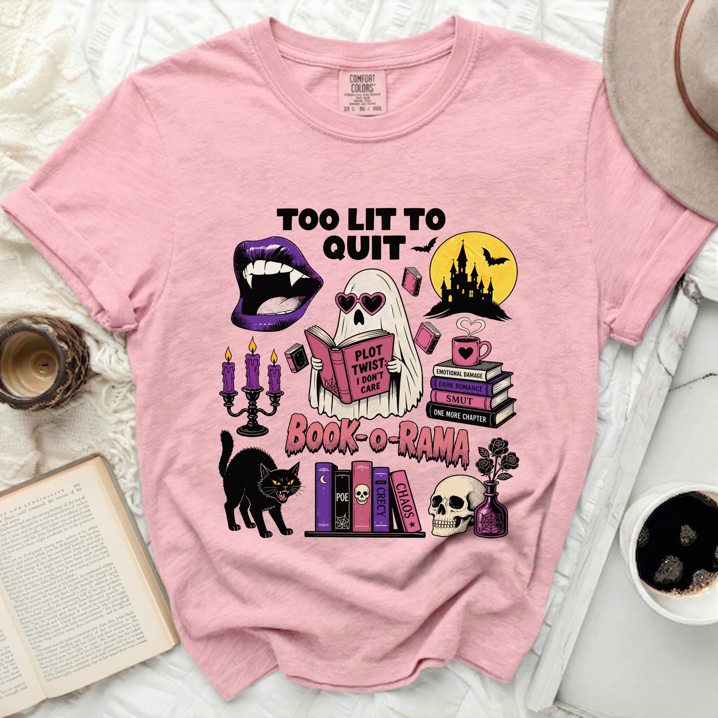 Pink t-shirt with "Too Lit to Quit" and spooky book-themed graphic.