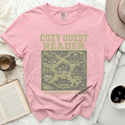 Pink t-shirt with "Cozy Quest" map of locations and text.