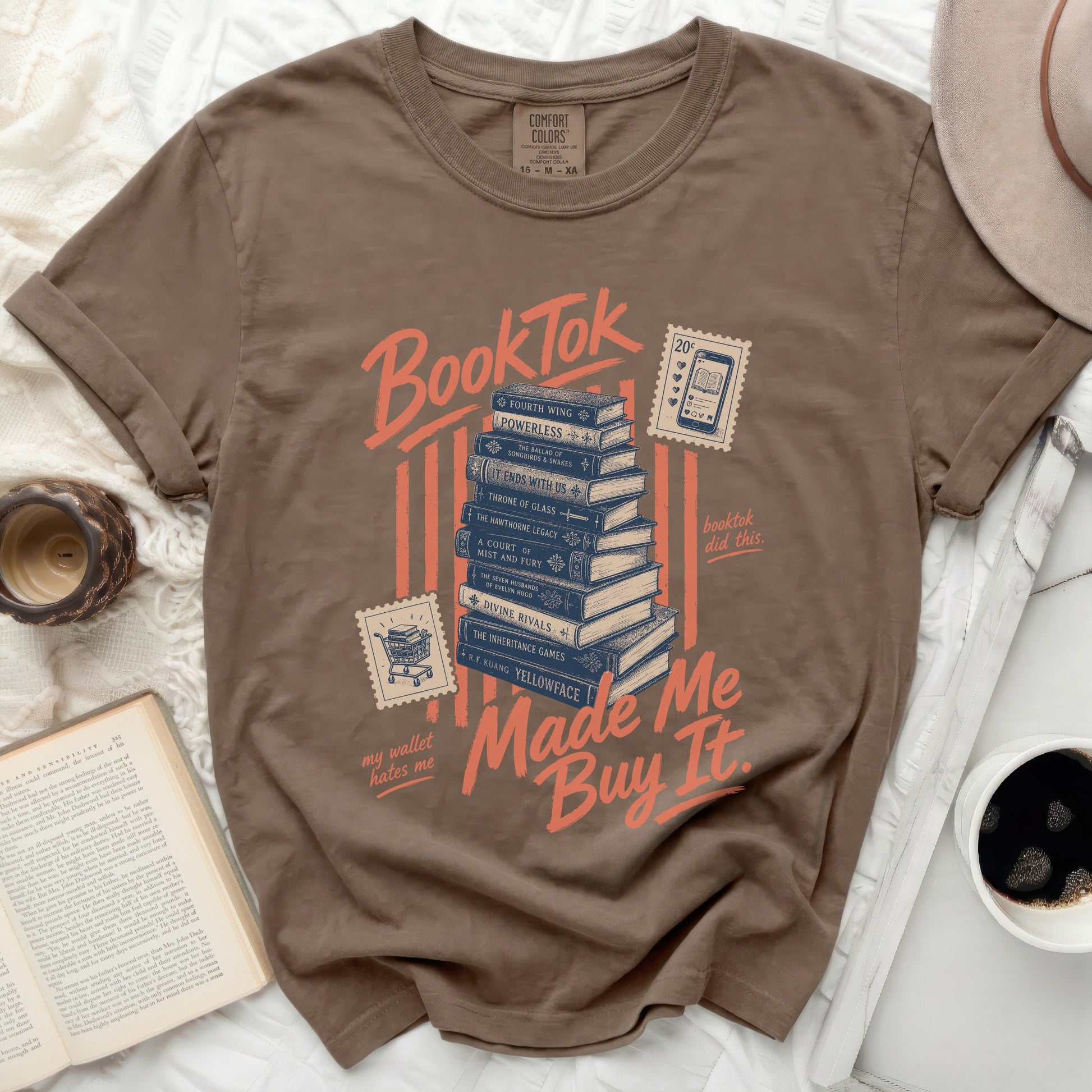Brown t-shirt with "BookTok Made Me Buy It" and stacked books graphic.