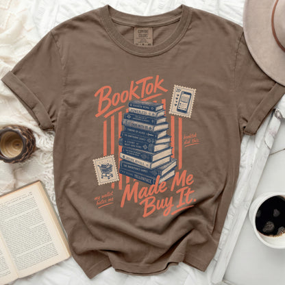 Brown t-shirt with "BookTok Made Me Buy It" and stacked books graphic.