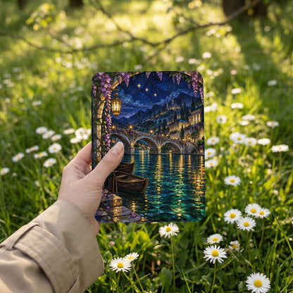 Hand holding stained glass artwork of a Venetian canal at night with bridge and boats.