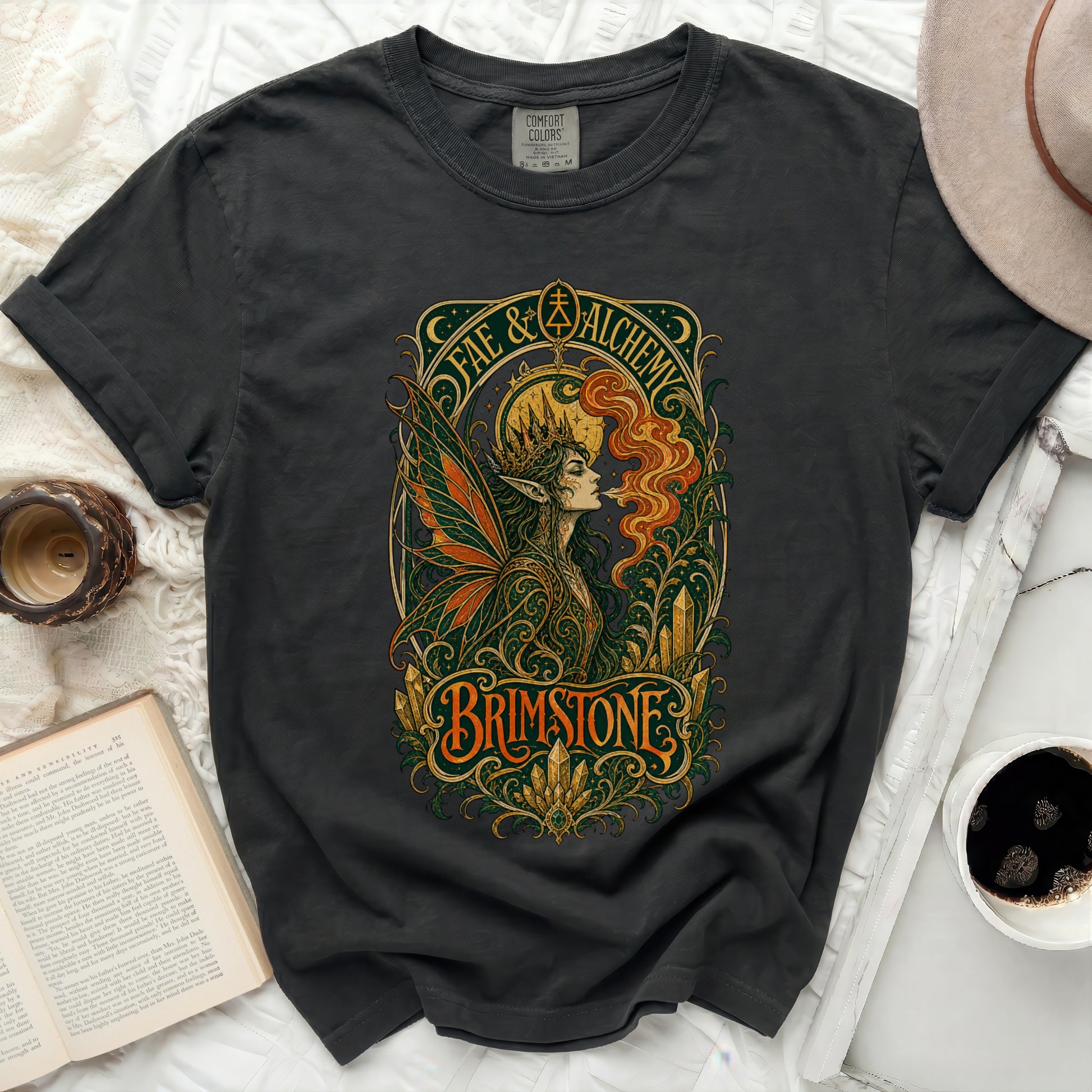 Dark t-shirt with "Fae & Alchemy Brimstone" graphic of a woman with wings and ornate details.